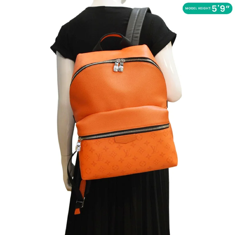 Louis Vuitton Twist bags with a crystal - embellished LV - turnlockLOUIS VUITTON Discovery Taiga leather Backpack Orange