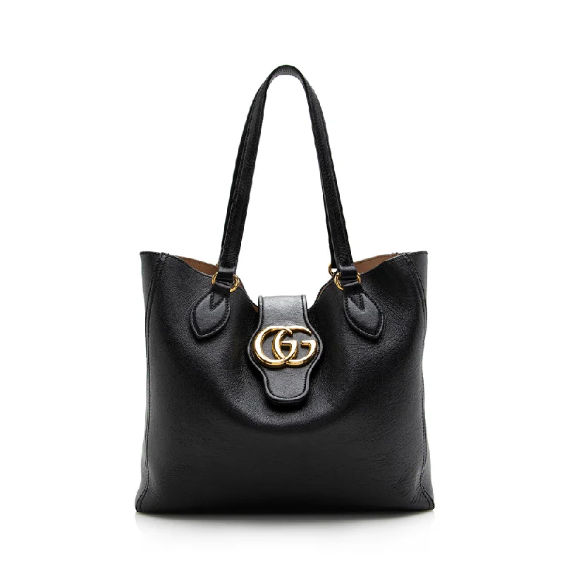 Women Gucci Sylvie bags featuring the signature web stripeGucci Leather Double G Small Tote